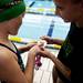 Plymouth Canton Cruiser swimmers inspect a medal after an award ceremony during the AAU Junior Olympics on Monday, July 29. Daniel Brenner I AnnArbor.com